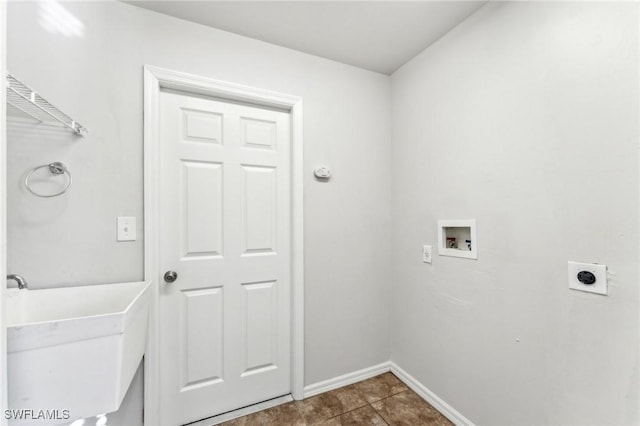 laundry area featuring laundry area, baseboards, electric dryer hookup, washer hookup, and a sink