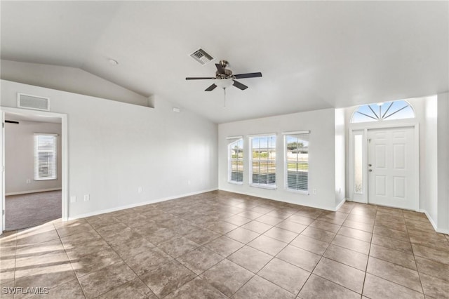 interior space with lofted ceiling, visible vents, a ceiling fan, and tile patterned floors