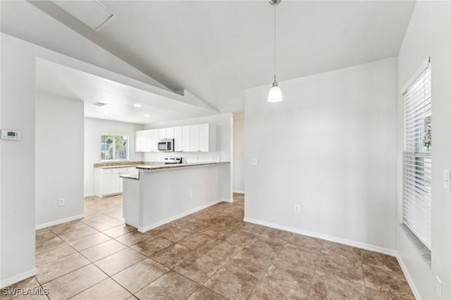 kitchen featuring lofted ceiling, stainless steel microwave, a peninsula, light countertops, and white cabinetry