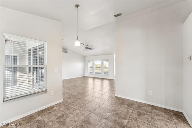 spare room featuring visible vents, baseboards, lofted ceiling, ceiling fan, and tile patterned floors