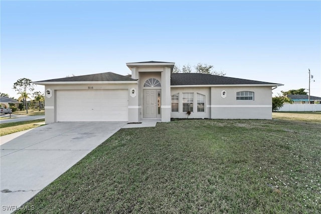 single story home with a garage, driveway, a front yard, and stucco siding