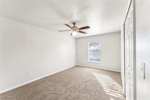 unfurnished bedroom with carpet, ceiling fan, and baseboards