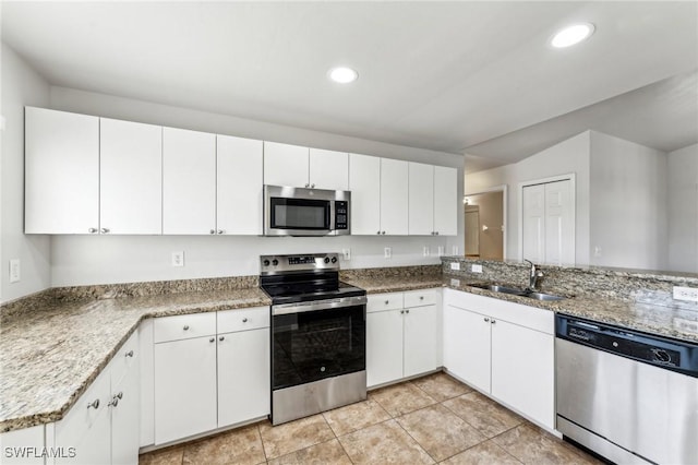 kitchen featuring appliances with stainless steel finishes, recessed lighting, white cabinetry, and a sink