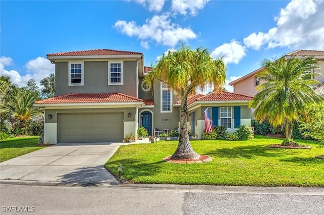 mediterranean / spanish house featuring an attached garage, concrete driveway, a tiled roof, stucco siding, and a front yard