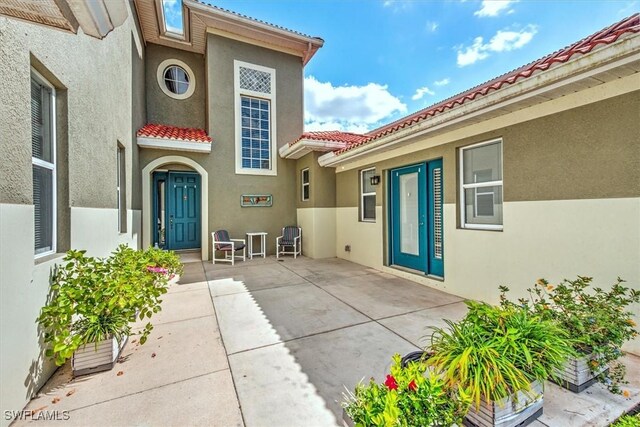 doorway to property with a patio