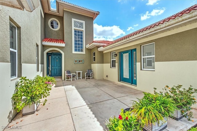 entrance to property featuring a patio