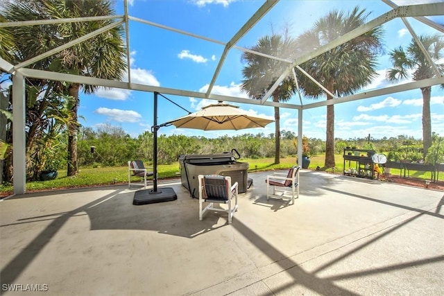 view of patio / terrace featuring a hot tub and a lanai