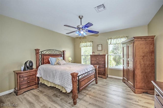 bedroom with ceiling fan and light hardwood / wood-style flooring