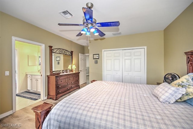 bedroom featuring ensuite bathroom, light carpet, ceiling fan, and a closet