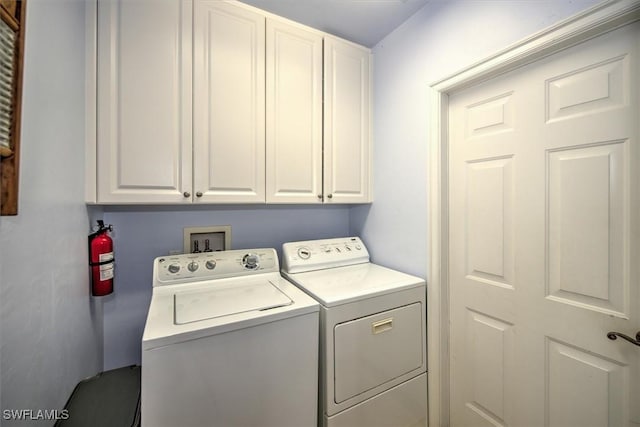 washroom featuring cabinets and independent washer and dryer