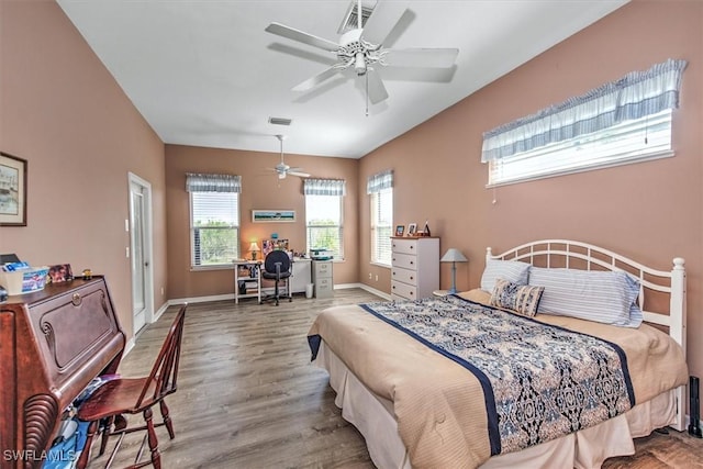 bedroom with hardwood / wood-style floors and ceiling fan