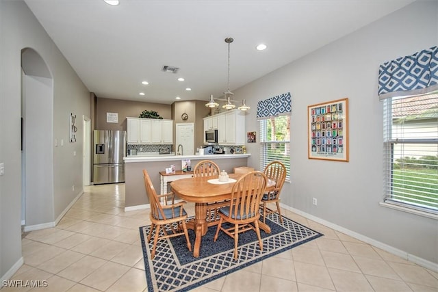 tiled dining room featuring sink