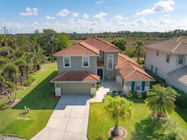 mediterranean / spanish home with a garage, a tiled roof, driveway, stucco siding, and a front yard