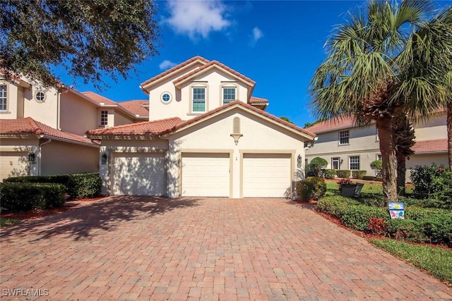 mediterranean / spanish home with a garage