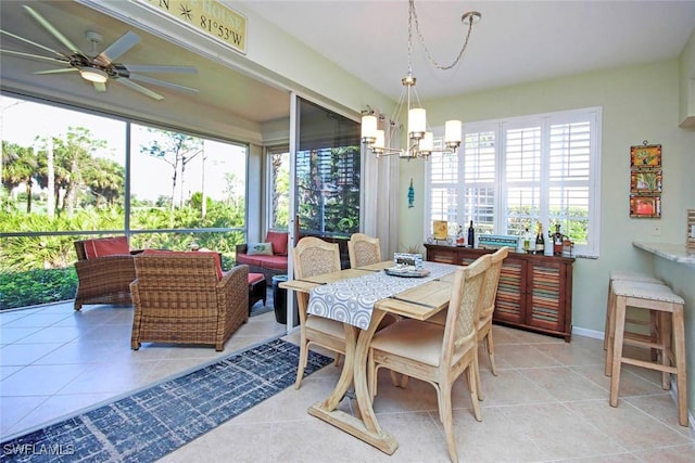 tiled dining area with ceiling fan with notable chandelier