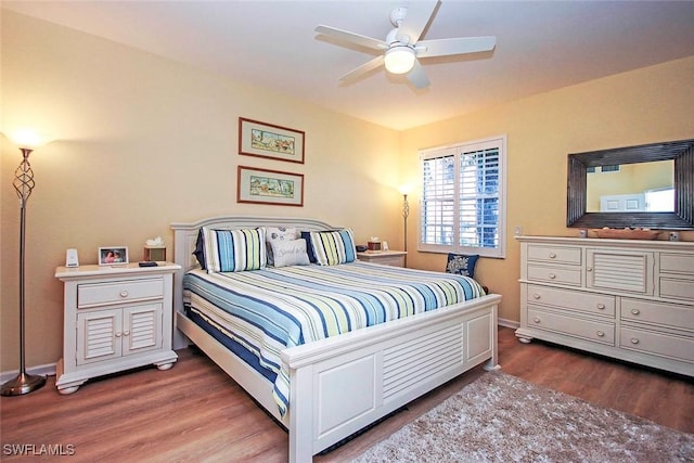 bedroom featuring dark hardwood / wood-style flooring and ceiling fan