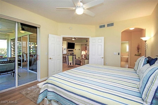 bedroom featuring hardwood / wood-style flooring, access to outside, ceiling fan, and ensuite bathroom