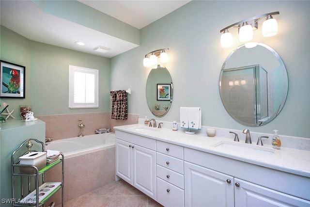 bathroom with vanity, tile patterned floors, and tiled bath