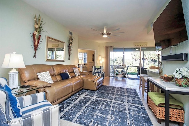 tiled living room with ceiling fan