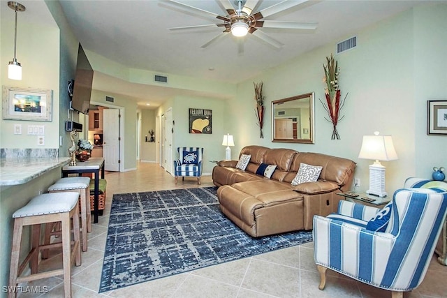 tiled living room featuring ceiling fan