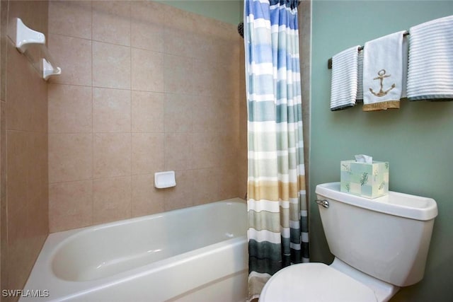 bathroom featuring shower / tub combo and toilet