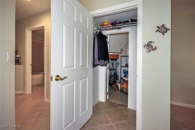 hall featuring dark tile patterned floors