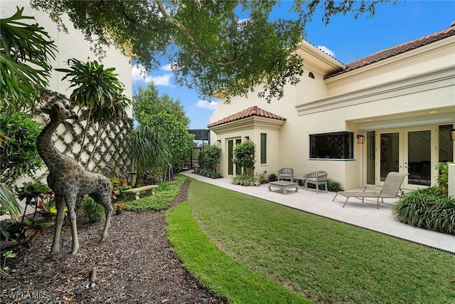 view of yard with a patio and french doors