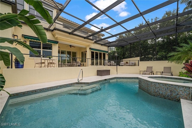 view of swimming pool with an in ground hot tub, ceiling fan, a lanai, and a patio area