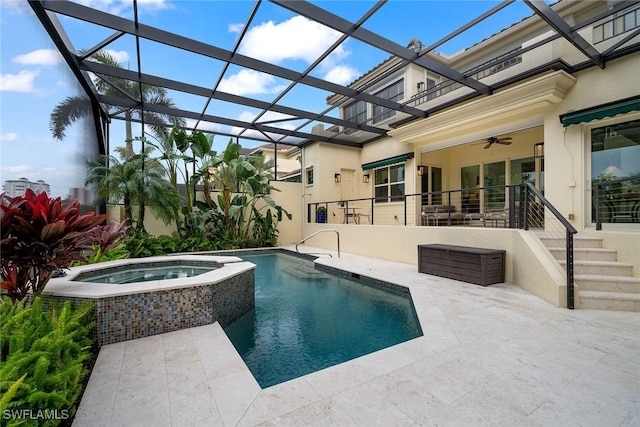 view of swimming pool with an in ground hot tub, glass enclosure, and a patio area