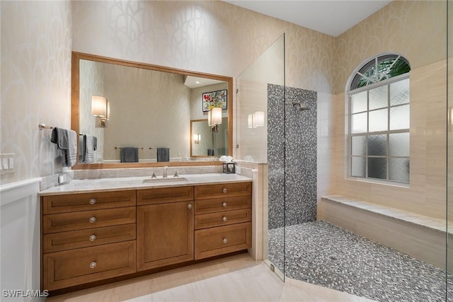 bathroom featuring vanity and a tile shower