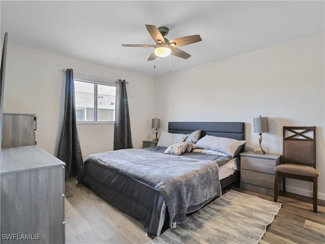 bedroom featuring hardwood / wood-style flooring and ceiling fan