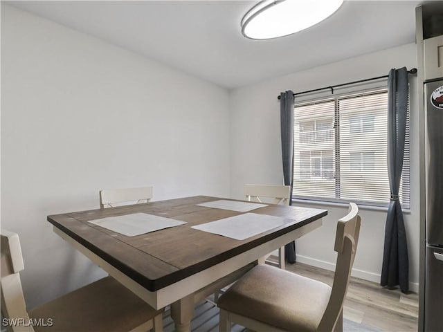 dining space featuring light wood-type flooring