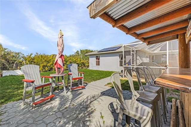 view of patio / terrace featuring a lanai