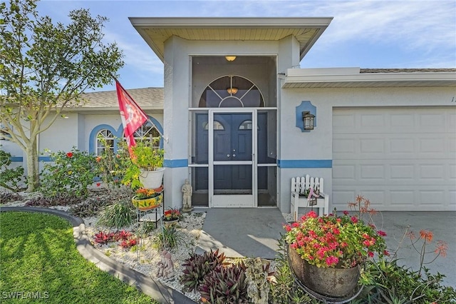 doorway to property with a garage