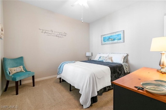 bedroom featuring baseboards and light colored carpet