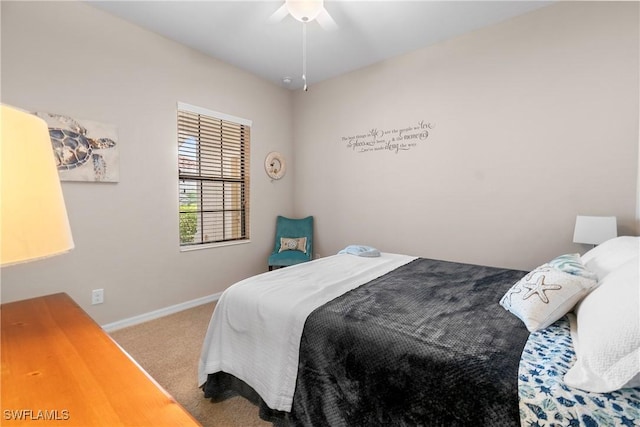 carpeted bedroom featuring a ceiling fan and baseboards