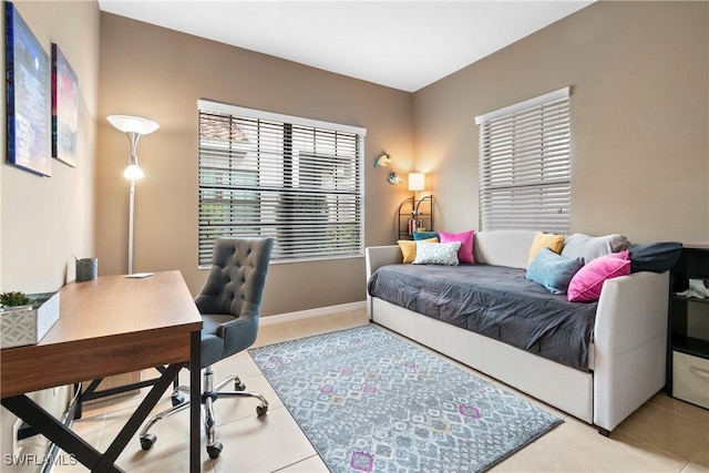 bedroom featuring tile patterned floors and baseboards