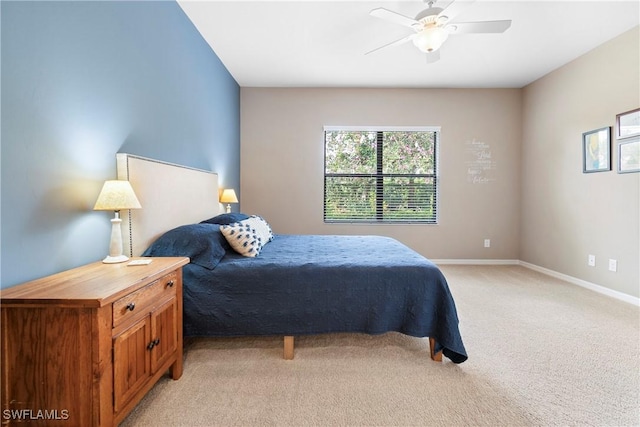 bedroom featuring a ceiling fan, light colored carpet, and baseboards