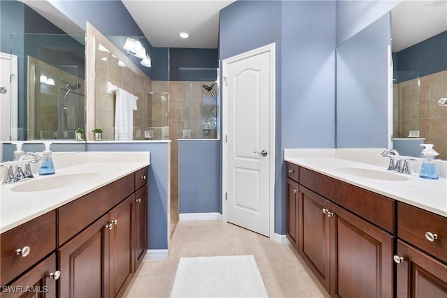 full bathroom featuring tile patterned flooring, two vanities, walk in shower, and a sink