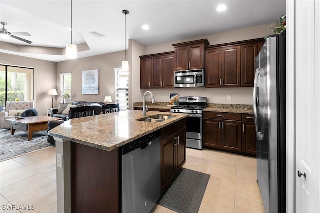 kitchen with light tile patterned floors, visible vents, appliances with stainless steel finishes, open floor plan, and a sink