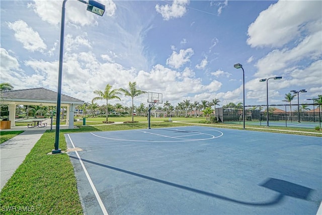 view of basketball court featuring community basketball court, fence, a lawn, and a gazebo