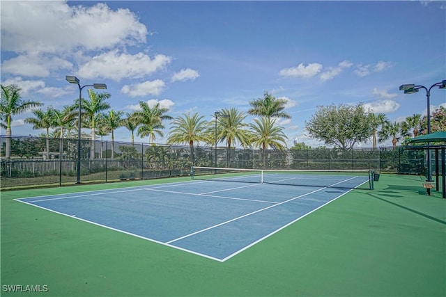 view of tennis court with fence