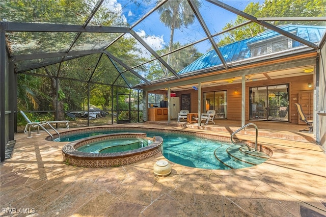 view of pool with an in ground hot tub, a lanai, and a patio