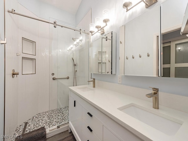 bathroom featuring vanity and a shower with door