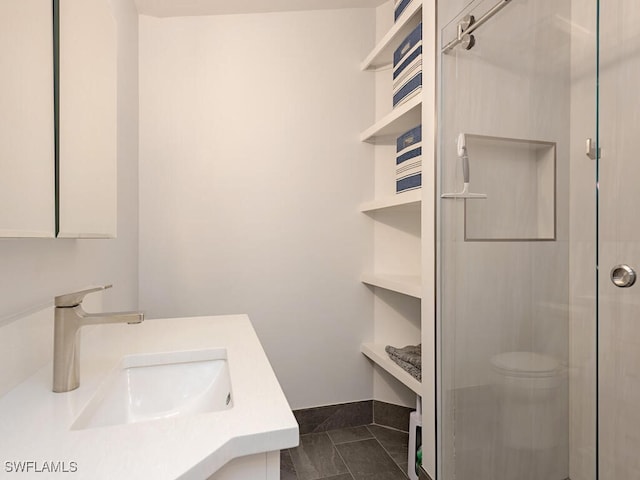 bathroom featuring tile patterned flooring, vanity, and a shower with door