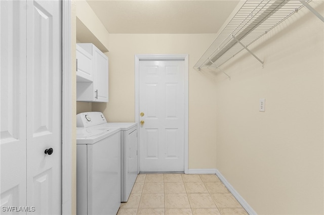 laundry room featuring cabinet space, independent washer and dryer, baseboards, and light tile patterned floors