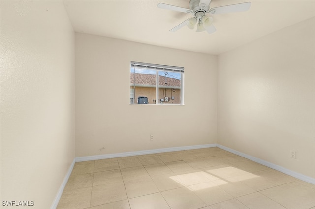 unfurnished room featuring a ceiling fan and baseboards