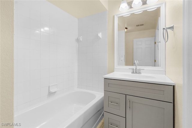 bathroom with shower / bath combination, vanity, and visible vents