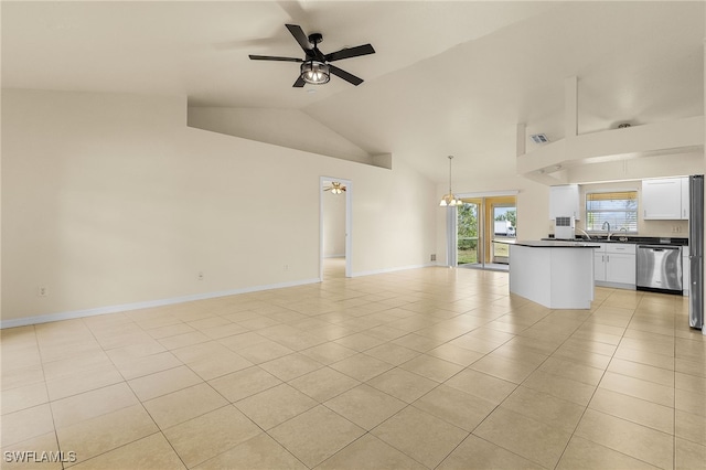 unfurnished living room featuring light tile patterned floors, baseboards, a ceiling fan, vaulted ceiling, and a sink