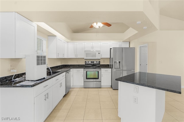 kitchen featuring appliances with stainless steel finishes, white cabinets, a ceiling fan, and light tile patterned flooring